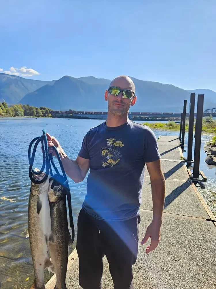 Dan outdoors beside a mountain lake